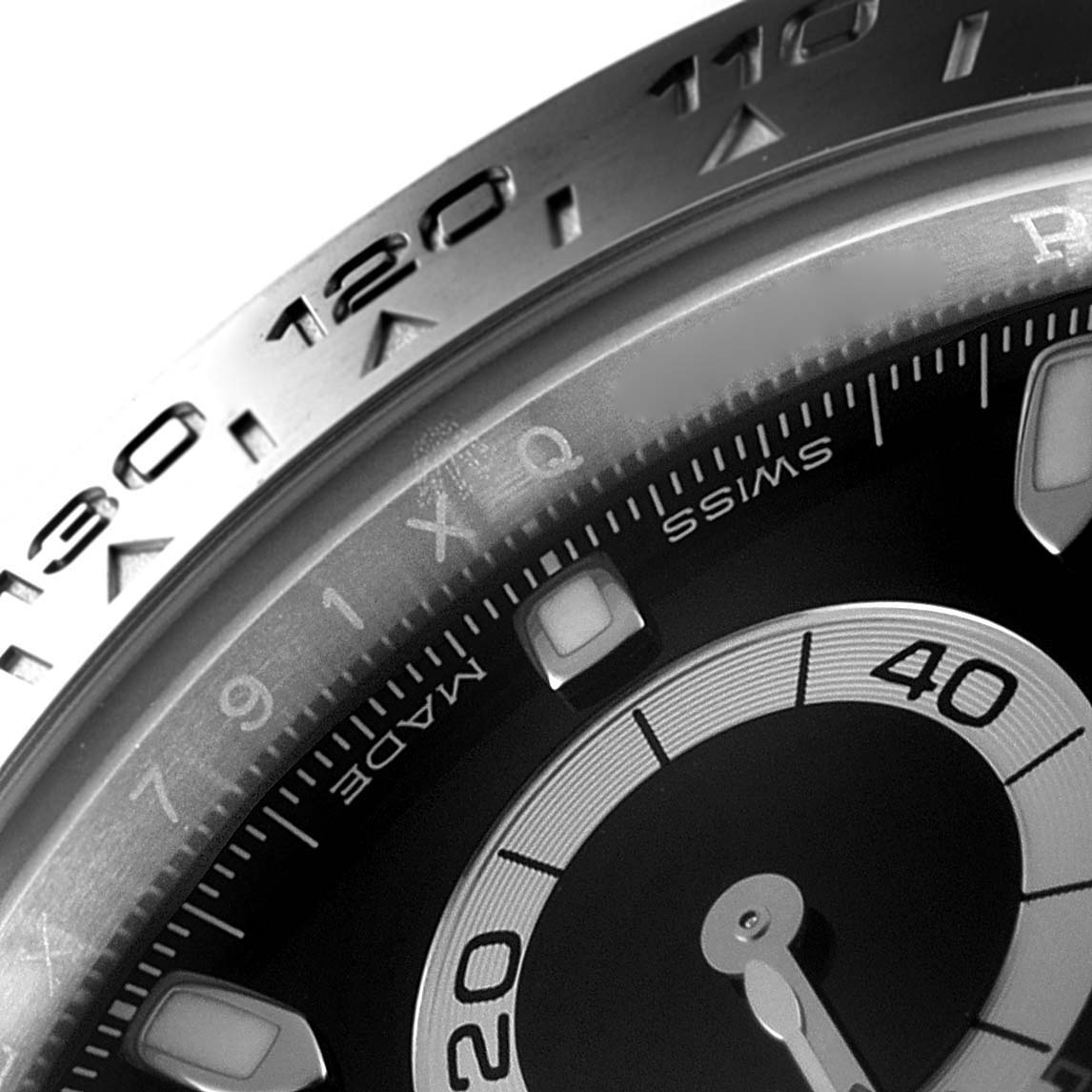 The image shows a close-up view of the bezel and part of the dial of a Rolex Daytona 116500 Men
s Stainless Steel Black Dial 116500 Men
s Stainless Steel Black Dial watch.