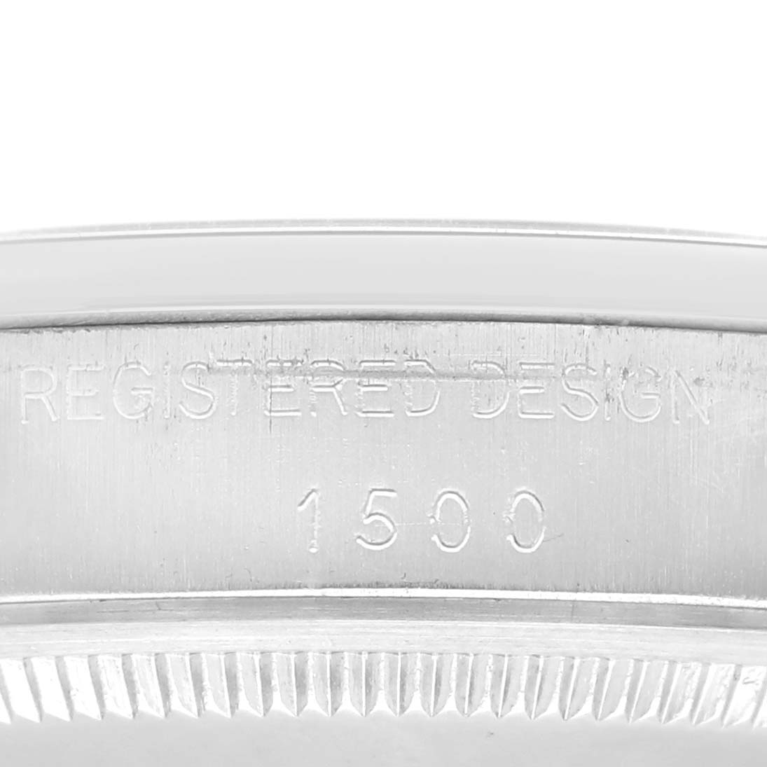 This image shows a close-up of the side of a Rolex Vintage Collection 1500 Men's Stainless Steel Silver Dial 1500 Men's Stainless Steel Silver Dial watch case, highlighting the engraving "REGISTERED DESIGN 1500".