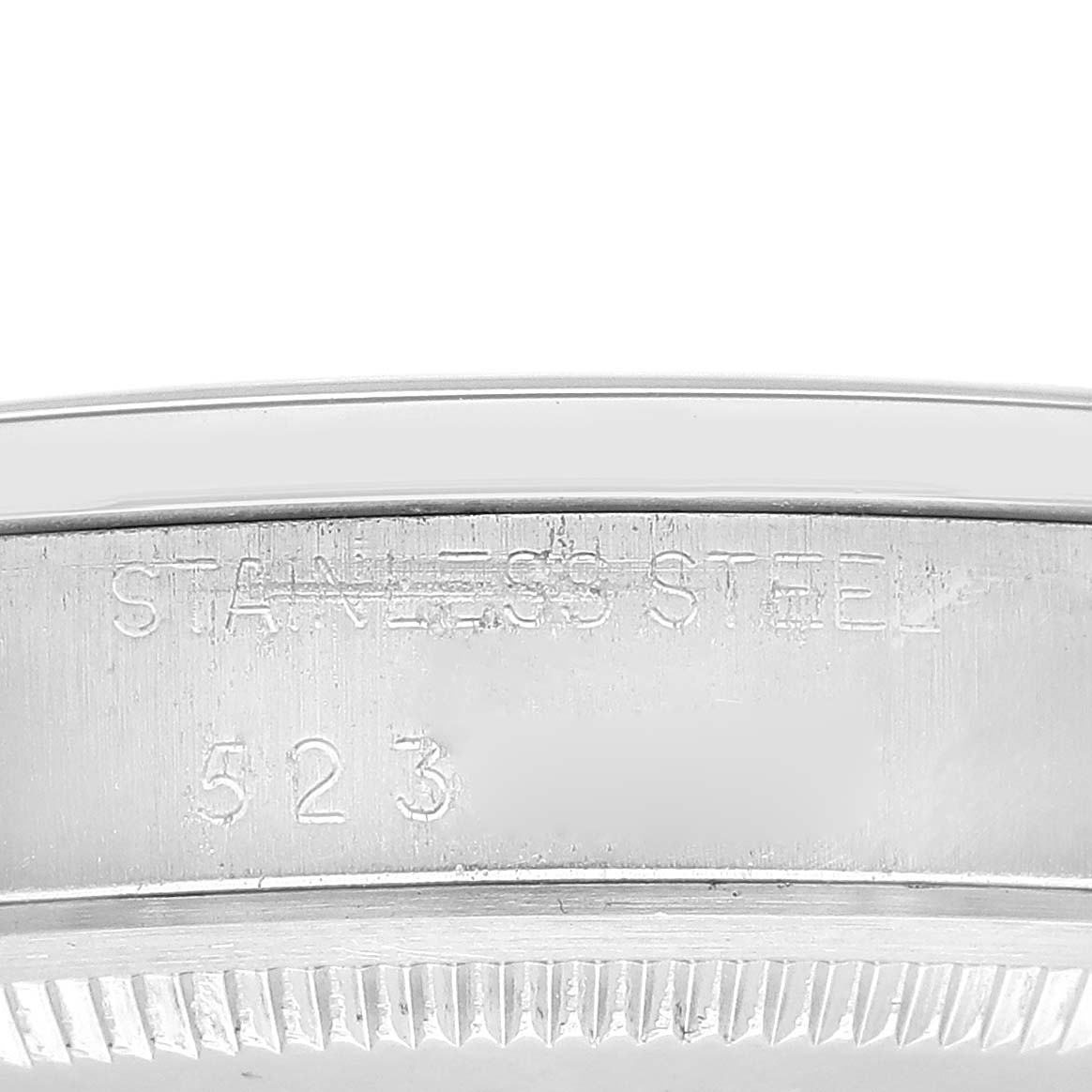 This image shows a close-up of the stainless steel inscription on the case back of a Vintage Collection model by Rolex.