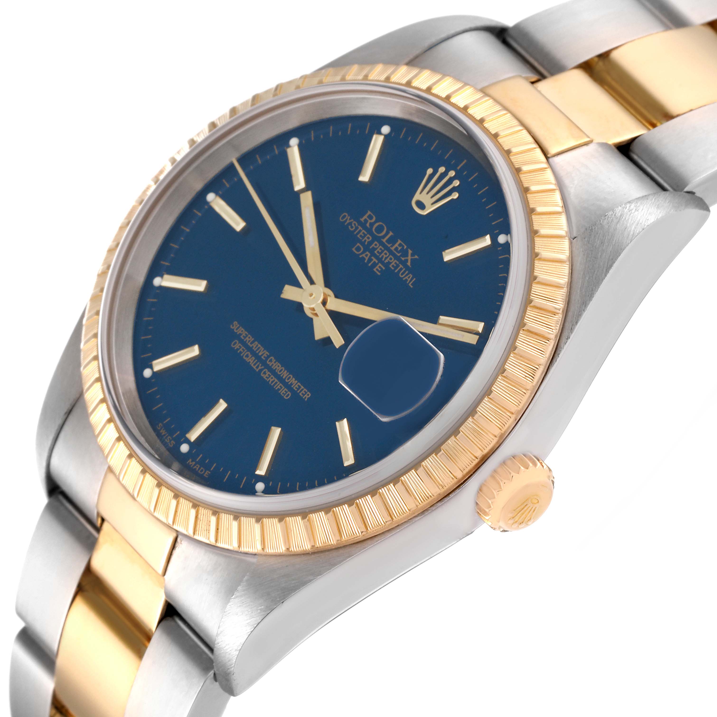 The image shows a Rolex Date 15223 Men
s Steel and Gold (two tone) Blue Dial 15223 Men
s Steel and Gold (two tone) Blue Dial watch at a slight angle, highlighting the blue dial, fluted bezel, and part of the bracelet.
