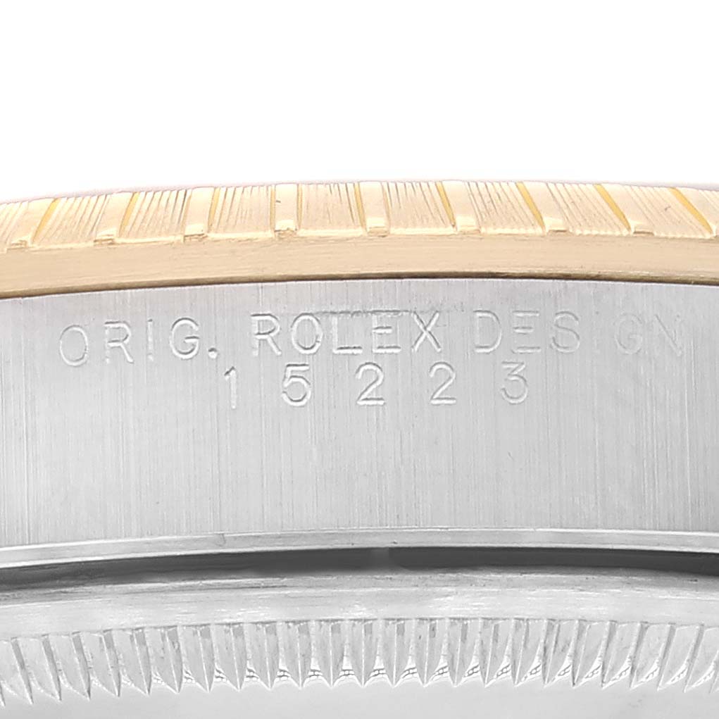 This image shows a close-up of the engraved case reference number on a Rolex Date 15223 Men
s Steel and Gold (two tone) Blue Dial 15223 Men
s Steel and Gold (two tone) Blue Dial model watch.
