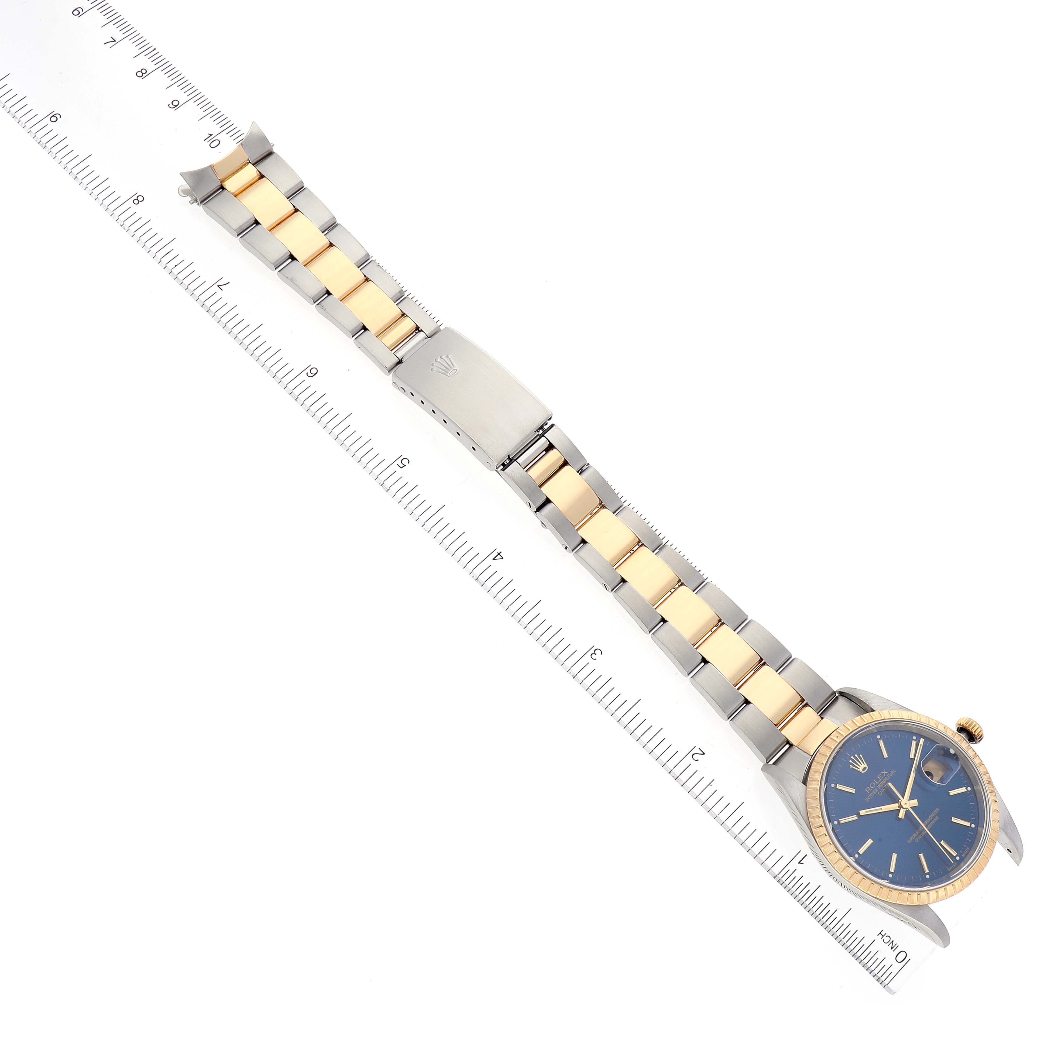 The Rolex Date 15223 Men
s Steel and Gold (two tone) Blue Dial 15223 Men
s Steel and Gold (two tone) Blue Dial model watch is shown from above, displaying the full band with a ruler alongside for scale.