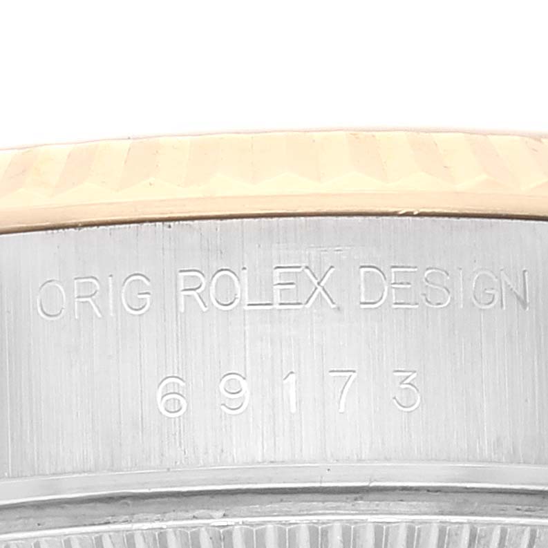 This image shows a close-up of the side engraving with "ORIG ROLEX DESIGN" and the model number "69173" on a Rolex Datejust 69173 Women's Steel and Gold (two tone) White Dial 69173 Women's Steel and Gold (two tone) White Dial watch.