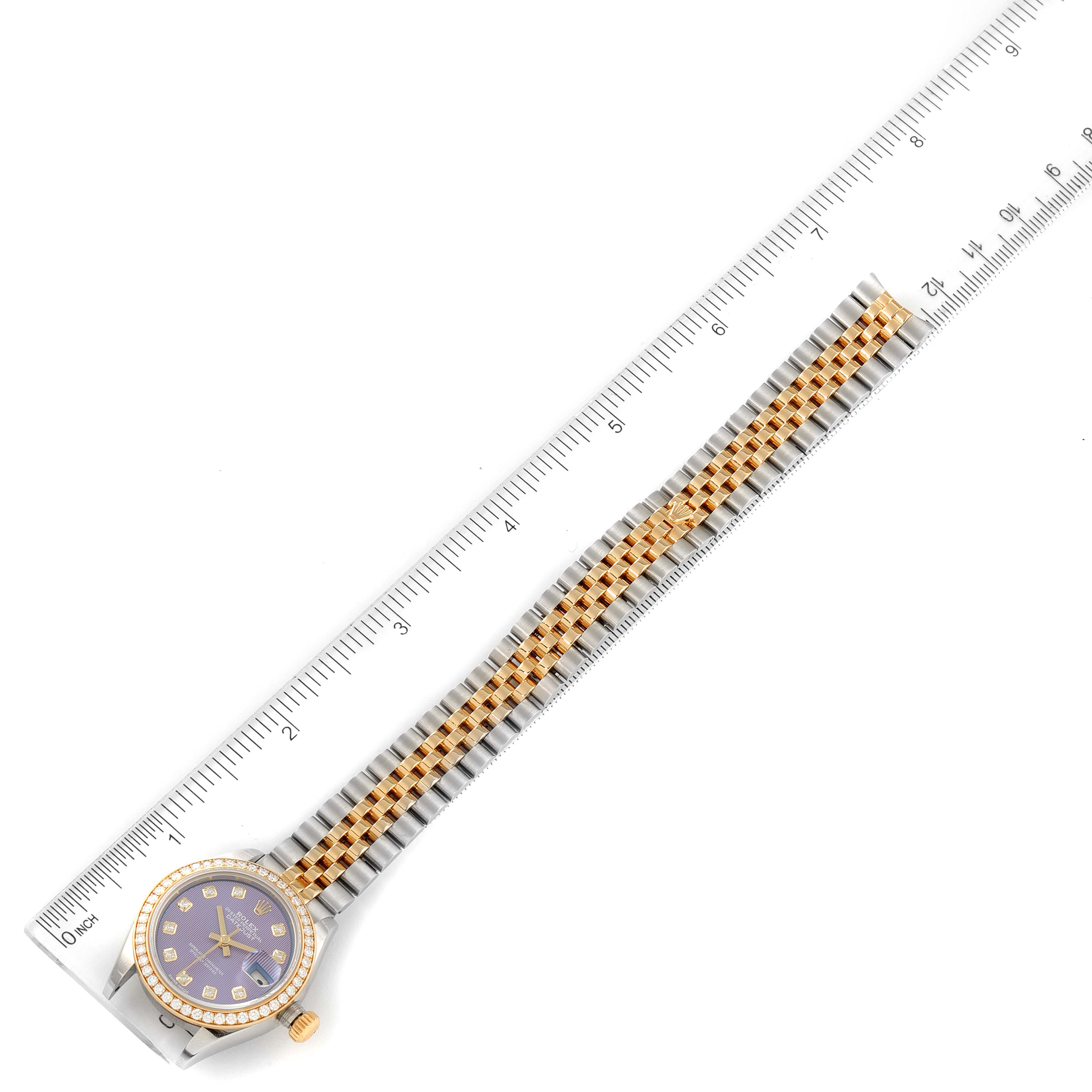 The image shows a Rolex Datejust 279383 Women's Steel and Gold (two tone) Purple Dial 279383 Women's Steel and Gold (two tone) Purple Dial model watch laid flat, displaying its face, bezel, bracelet, and a measuring ruler.