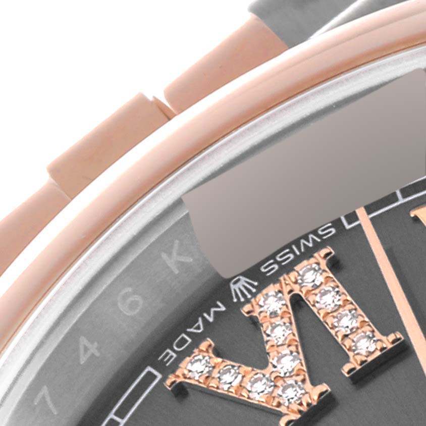 This close-up image of a Rolex Datejust 126201 Men
s Steel and Gold (two tone) Grey Dial 126201 Men
s Steel and Gold (two tone) Grey Dial watch shows a portion of the dial, including diamond-studded Roman numerals and part of the bezel.