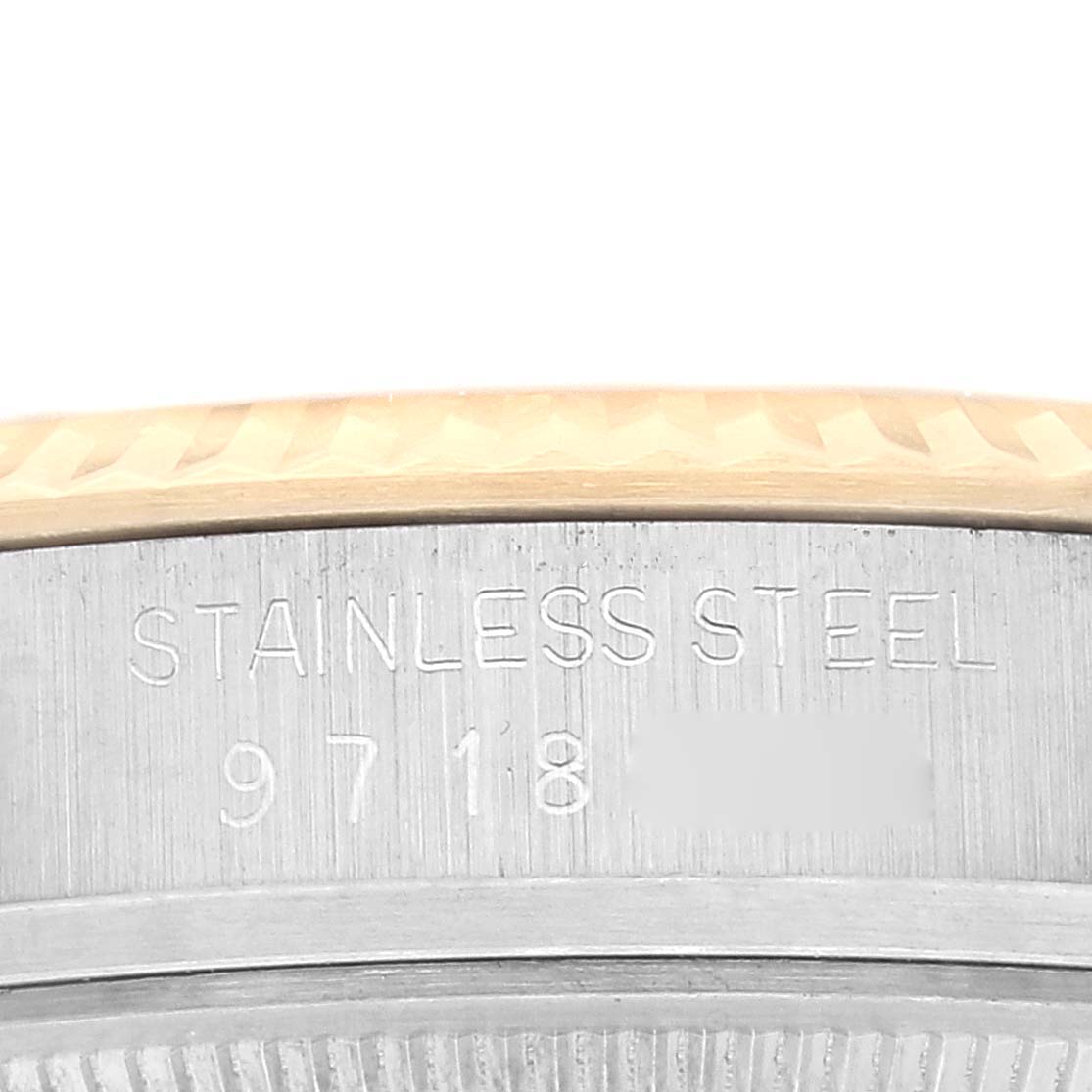 The image shows a close-up of the side of a Rolex Vintage Collection 16013 Men's Steel and Gold (two tone) Champagne Dial 16013 Men's Steel and Gold (two tone) Champagne Dial watch, highlighting the stainless steel bezel with engraved text.