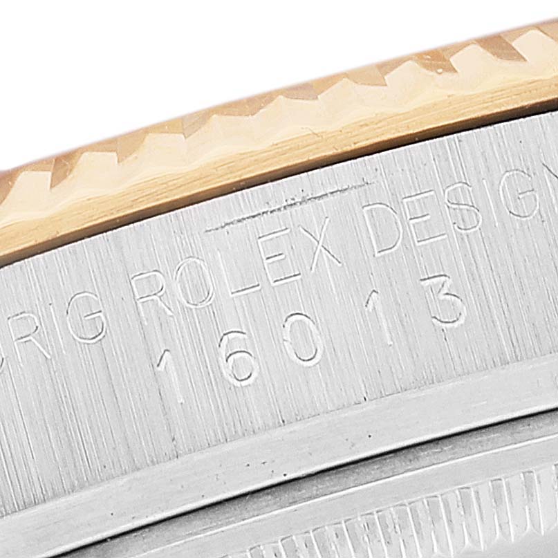 This image shows a close-up of the engraved bezel and case of the Rolex Vintage Collection 16013 Men's Steel and Gold (two tone) Silver Dial 16013 Men's Steel and Gold (two tone) Silver Dial model 16013.