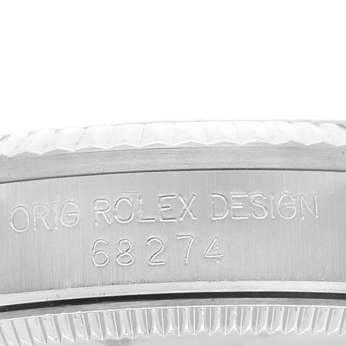 This image shows a close-up of the side case with engraved serial number and text on a Rolex Mid-Size 68274 Women
s Stainless Steel Silver Dial 68274 Women
s Stainless Steel Silver Dial model.