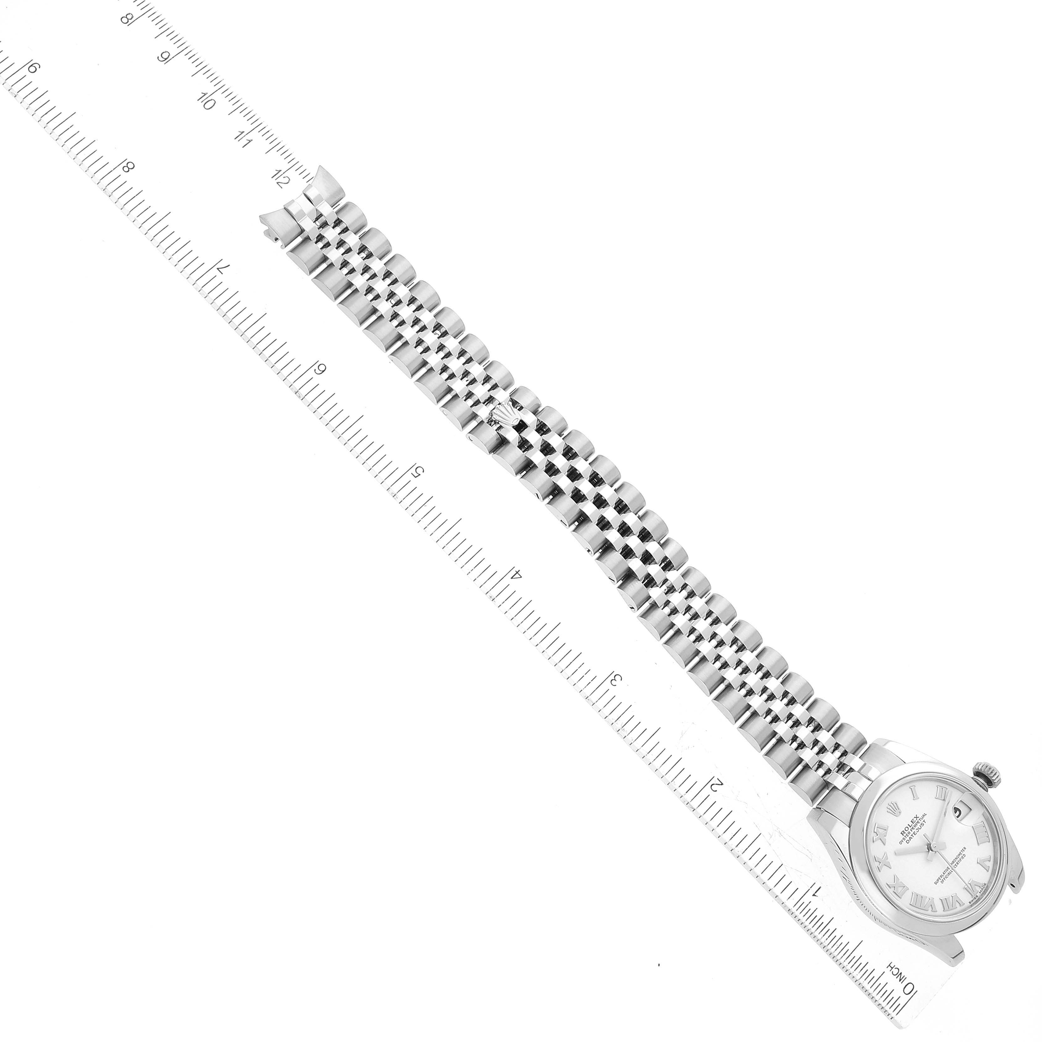 The image shows a Mid-Size Rolex watch laid flat with its bracelet extended, measured against a ruler.