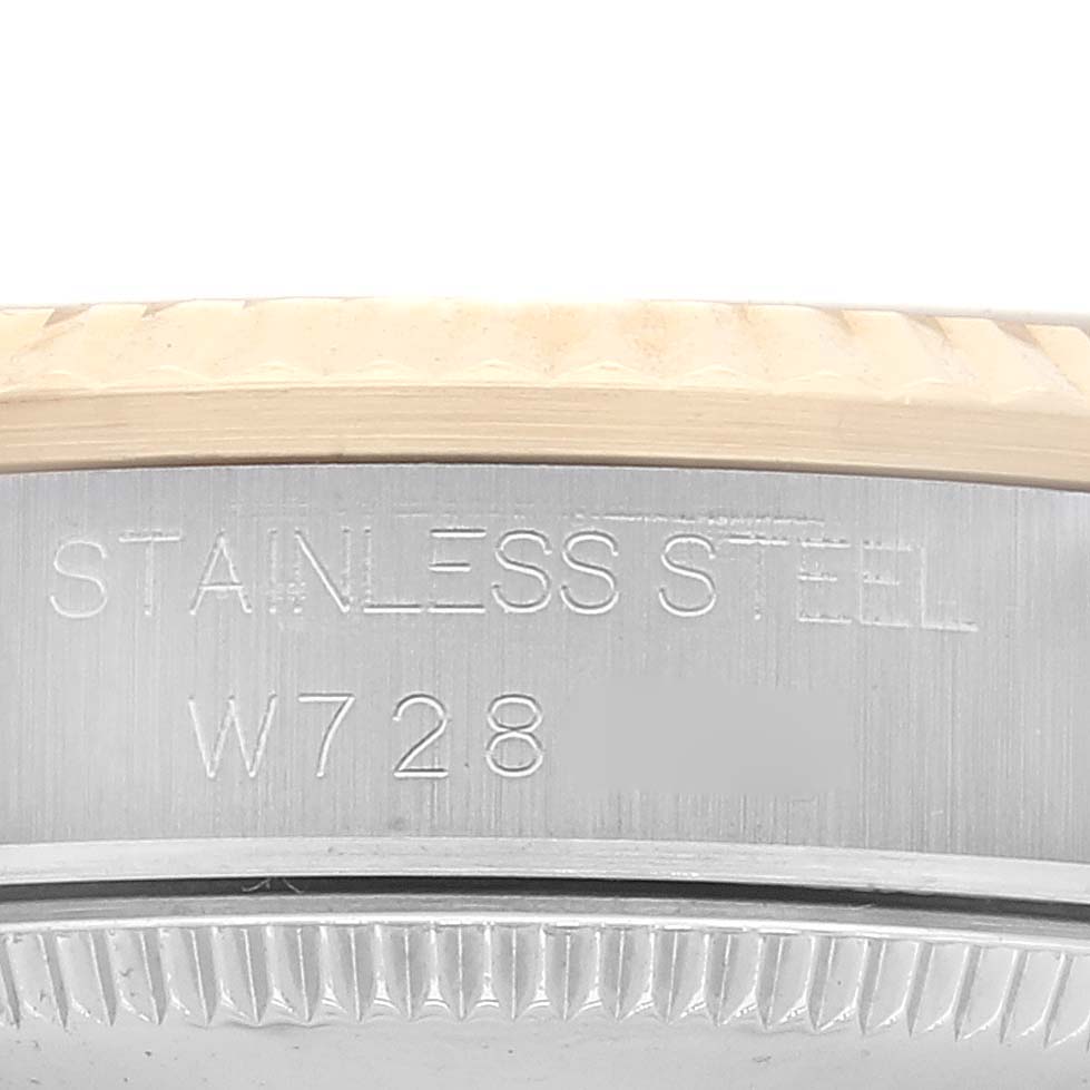 The image shows a close-up of the side view of a mid-size Rolex watch, highlighting the stainless steel case and some engravings.
