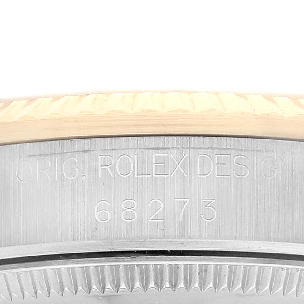 The image shows an up-close view of the bezel and case side of a Rolex Mid-Size 68273 Women
s Steel and Gold (two tone) Champagne Dial 68273 Women
s Steel and Gold (two tone) Champagne Dial model, highlighting the model number 68273.