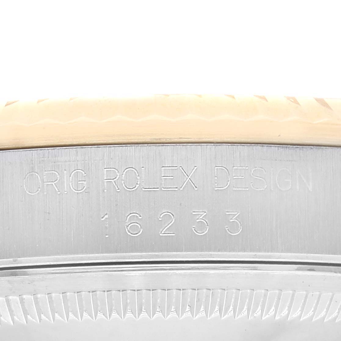 The image shows a close-up of the case side of a Rolex Datejust 16233 Men's Steel and Gold (two tone) Champagne Dial 16233 Men's Steel and Gold (two tone) Champagne Dial model, highlighting its engraved design and model number 16233.