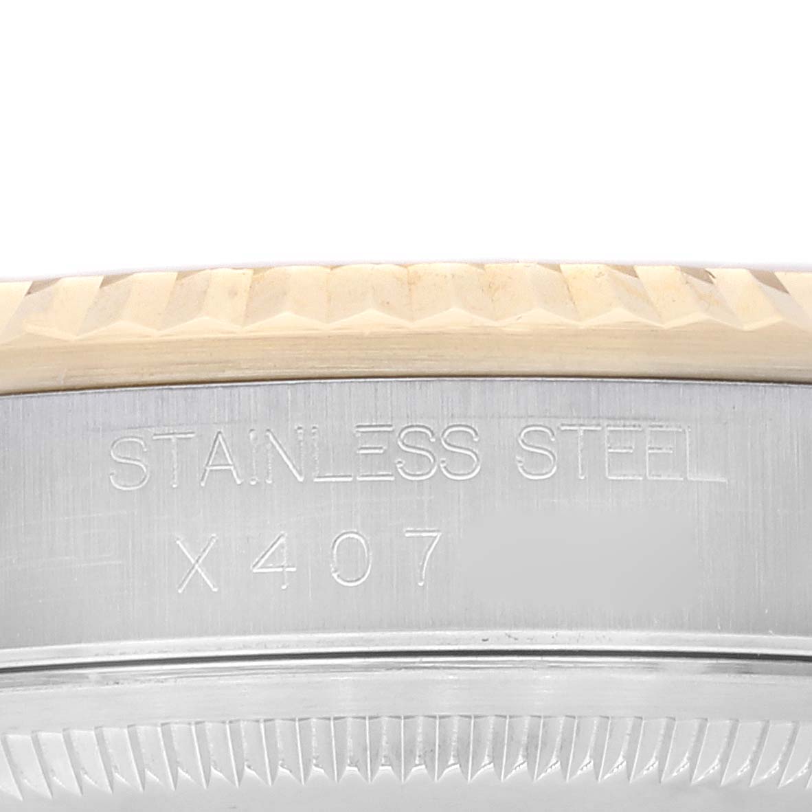 This image shows the side profile of the bezel and case of the Rolex Datejust 16233 Men's Steel and Gold (two tone) Champagne Dial 16233 Men's Steel and Gold (two tone) Champagne Dial watch, highlighting its stainless steel engraving.