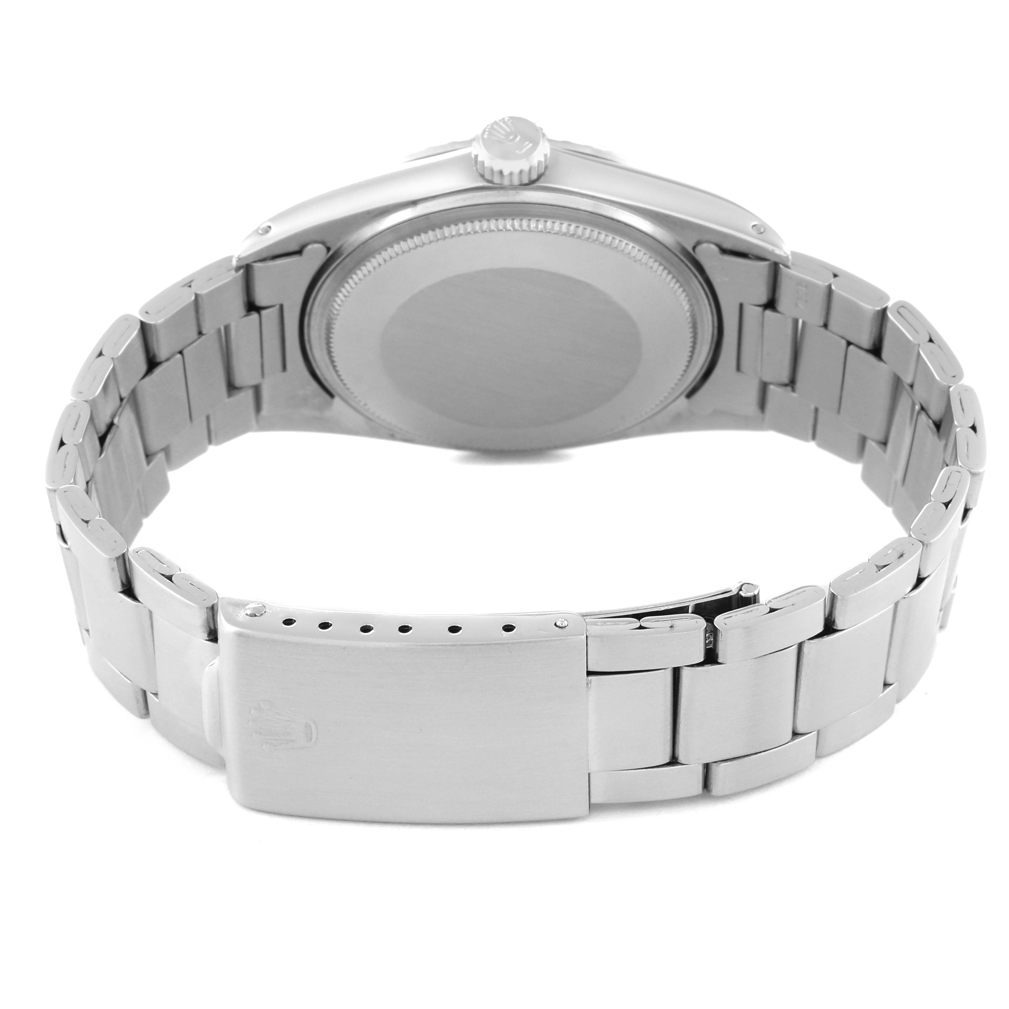 The image shows the back view of a Rolex Vintage Collection 1601 Men's Stainless Steel Silver Dial 1601 Men's Stainless Steel Silver Dial watch, highlighting its case, crown, and metal bracelet.