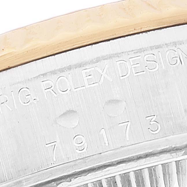 This close-up image shows the model number and "ORIG. ROLEX DESIGN" engraving on the side of the Rolex Datejust 79173 Women's Steel and Gold (two tone) Black Dial 79173 Women's Steel and Gold (two tone) Black Dial watch case.