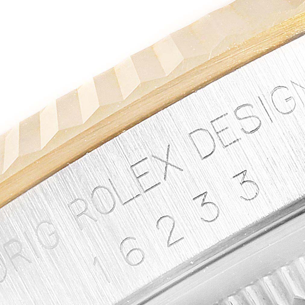 The image shows a close-up of the side of the bezel and case of the Rolex Datejust 16233 Men
s Steel and Gold (two tone) Black Dial 16233 Men
s Steel and Gold (two tone) Black Dial model, highlighting the engraved text.