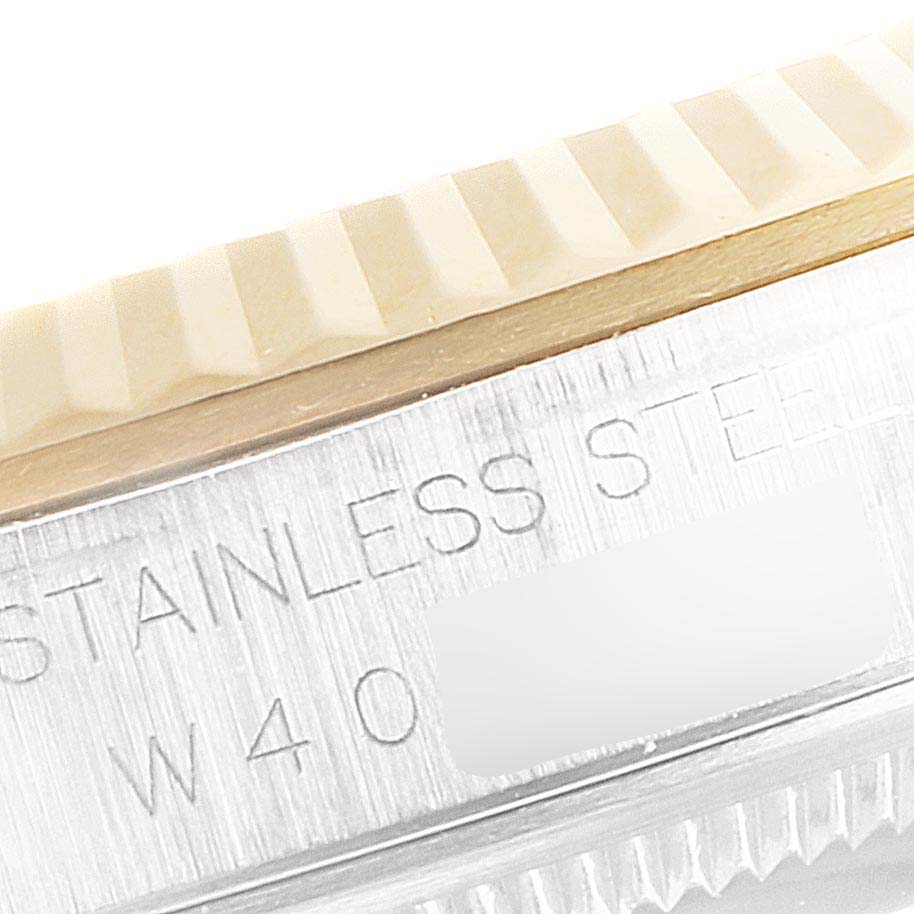 This image shows a close-up of the engraved side and fluted bezel of a Rolex Datejust 16233 Men
s Steel and Gold (two tone) Black Dial 16233 Men
s Steel and Gold (two tone) Black Dial watch, highlighting the "Stainless Steel" marking.