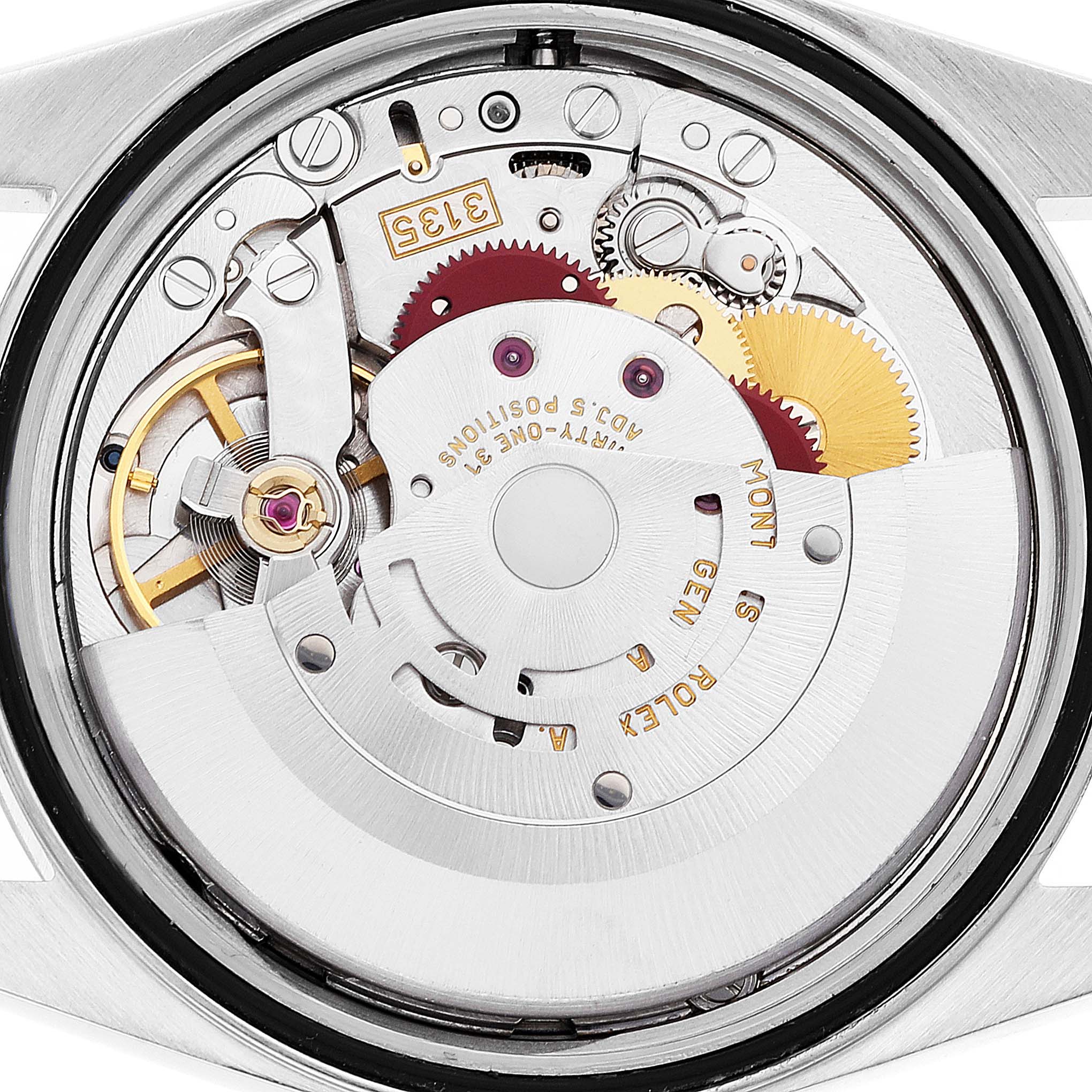 The image shows a close-up of the movement mechanism of a Rolex Datejust 16233 Men's Steel and Gold (two tone) Blue Dial 16233 Men's Steel and Gold (two tone) Blue Dial watch, highlighting gears, balance wheel, and rotor.