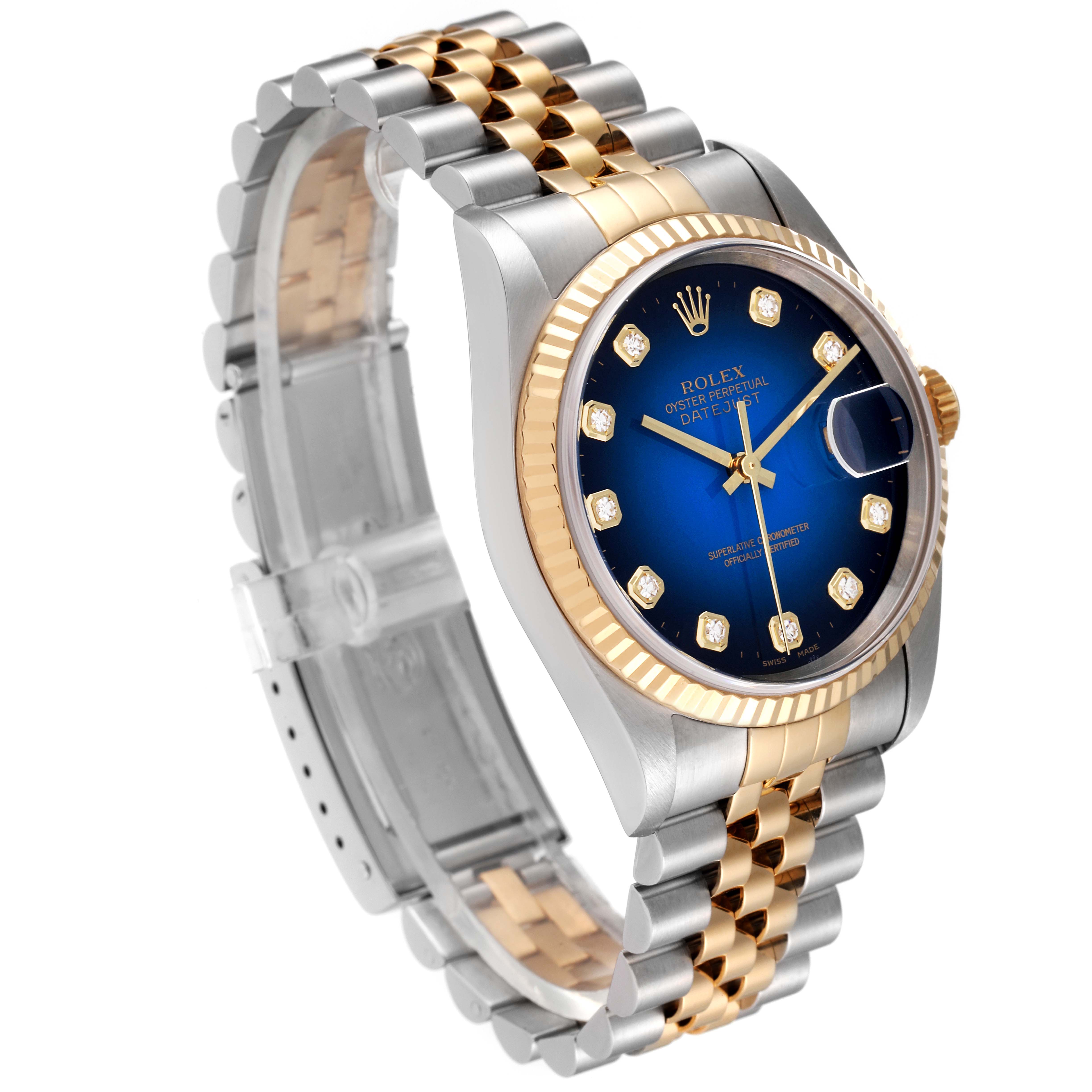 The image shows a Rolex Datejust 16233 Men's Steel and Gold (two tone) Blue Dial 16233 Men's Steel and Gold (two tone) Blue Dial watch from an oblique angle, highlighting its two-tone bracelet, blue dial, and fluted bezel.