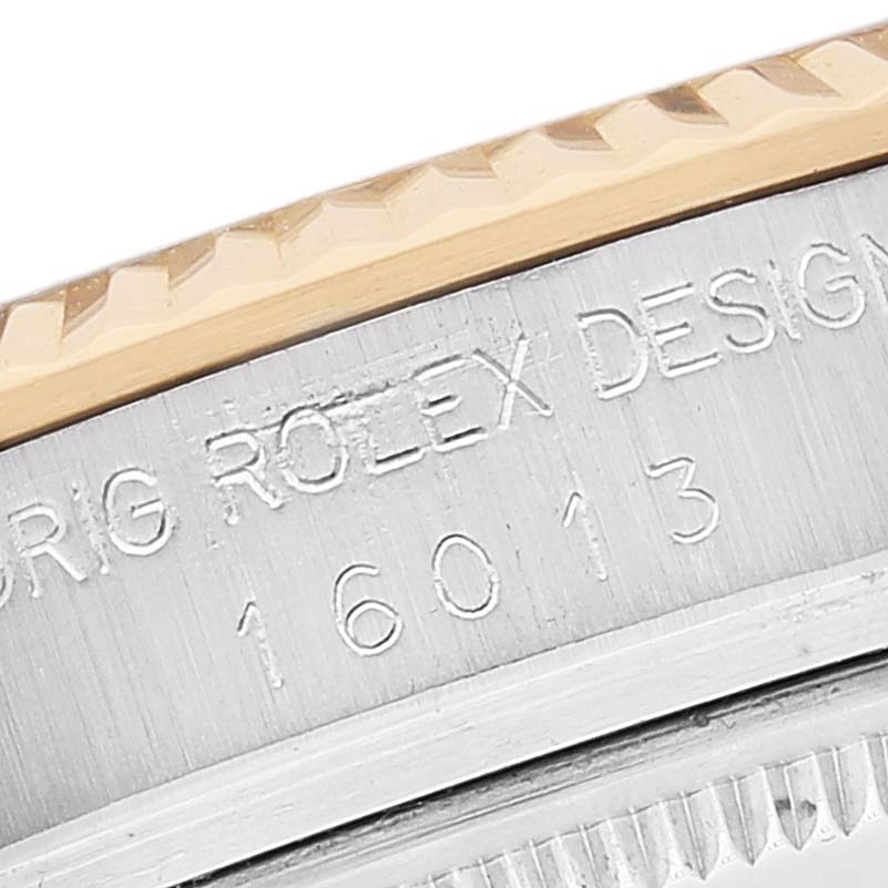 This close-up image shows the engraved edge of the bezel and case of a Rolex Vintage Collection 16013 Men's Steel and Gold (two tone) White Dial 16013 Men's Steel and Gold (two tone) White Dial model 16013.