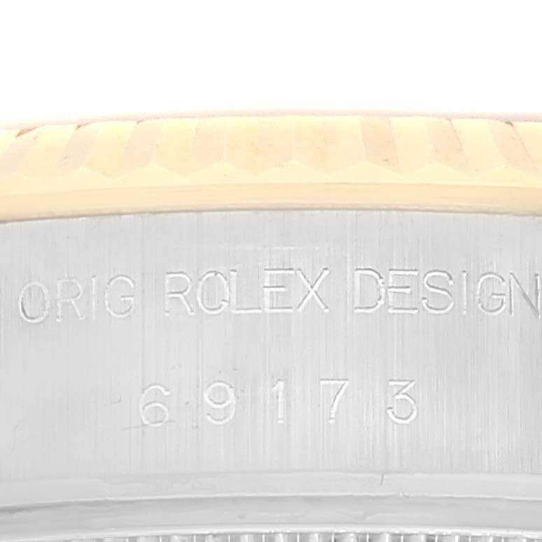This is an image of the edge engraving on the Rolex Datejust 69173 Women's Steel and Gold (two tone) Champagne Dial 69173 Women's Steel and Gold (two tone) Champagne Dial watch, showing the model number and "ORIG ROLEX DESIGN" text.