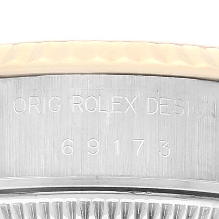 This close-up picture shows the engraved side view of a Rolex Datejust 69173 Women's Steel and Gold (two tone) Champagne Dial 69173 Women's Steel and Gold (two tone) Champagne Dial watch case with design and model number.