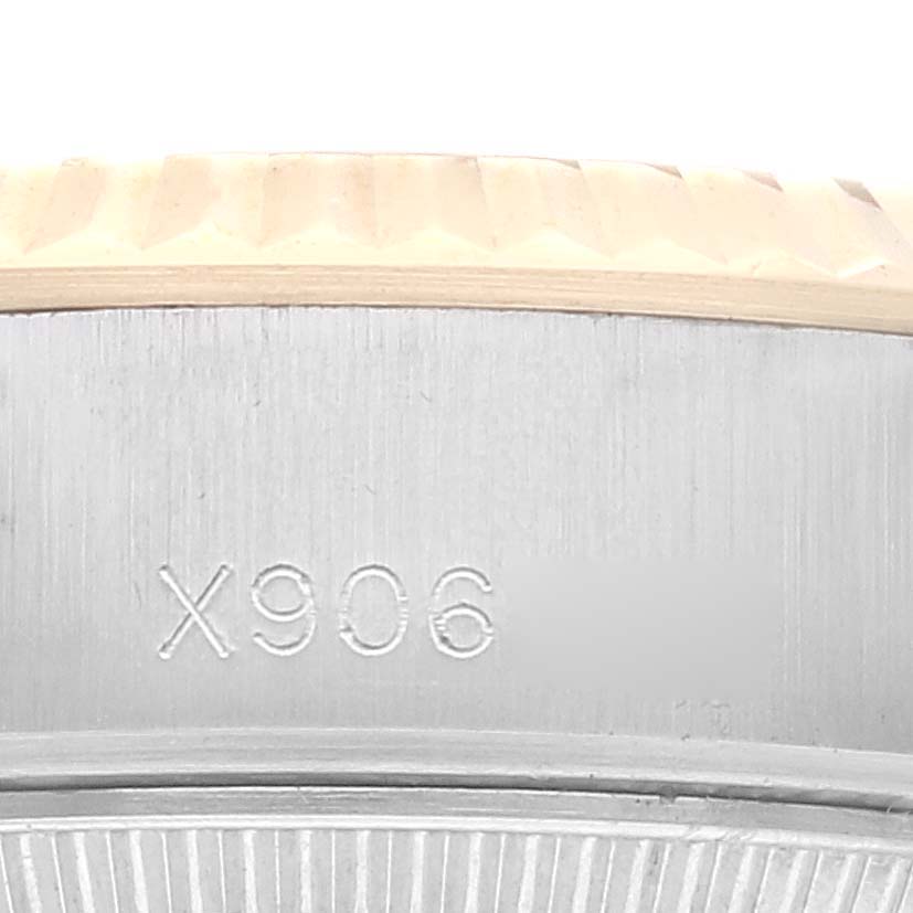 The image shows a close-up view of the Rolex Datejust 69173G Women's Steel and Gold (two tone) Champagne Dial 69173G Women's Steel and Gold (two tone) Champagne Dial model, focusing on the bezel and case with visible serial numbers.