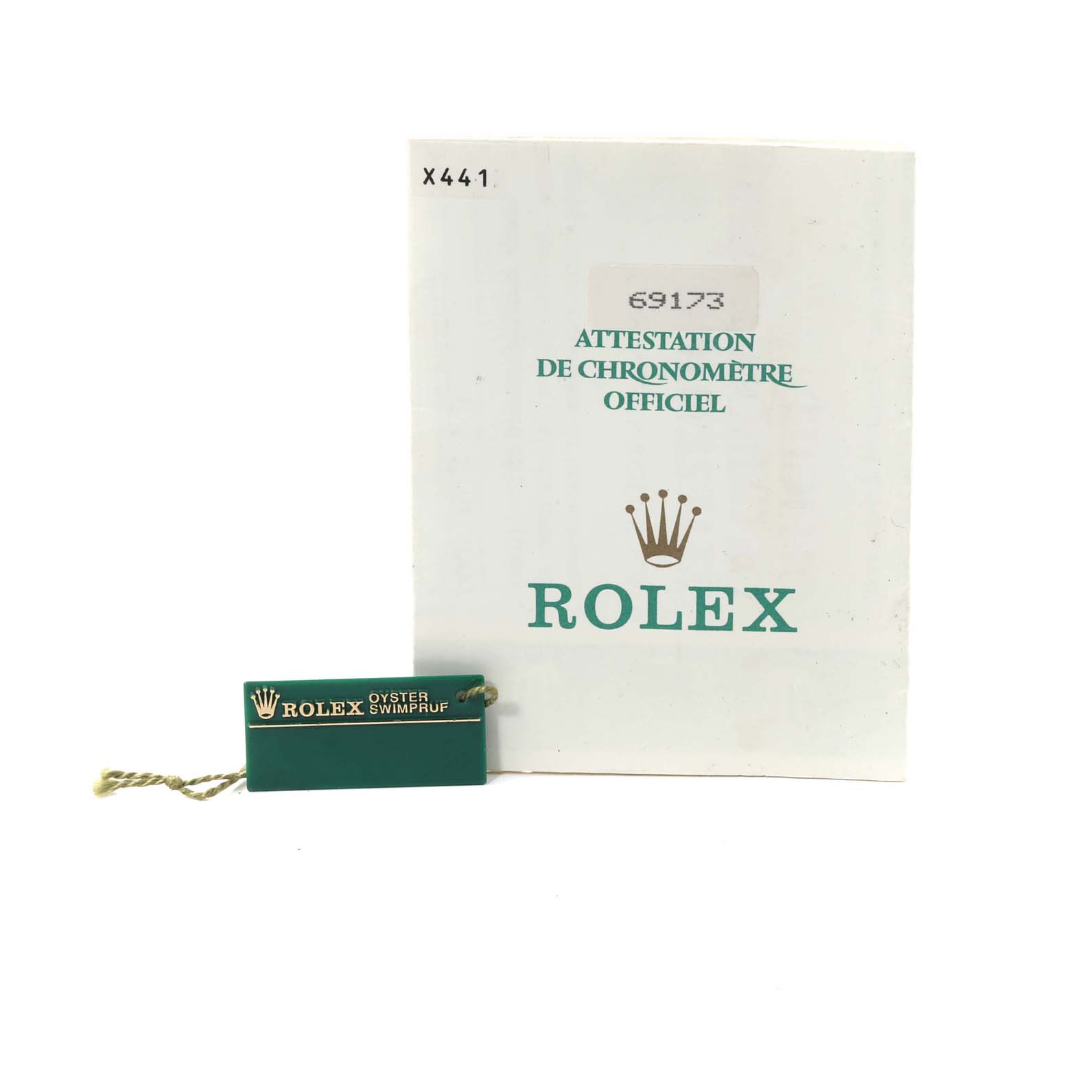 The image shows a Rolex Datejust 69173 Women's Steel and Gold (two tone) Champagne Dial 69173 Women's Steel and Gold (two tone) Champagne Dial booklet and an attached green tag labeled "Oyster Swimpruf" from a front-facing angle.