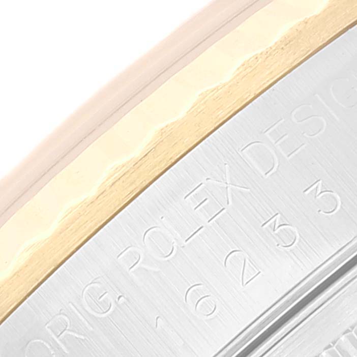 This close-up image shows the edge of a Rolex Datejust 16233 Men's Steel and Gold (two tone) Silver Dial 16233 Men's Steel and Gold (two tone) Silver Dial watch case with visible engravings.