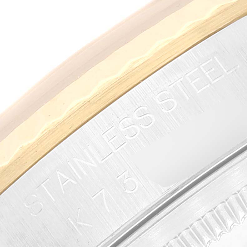 The image shows a close-up of the stainless steel and gold bezel edge of a Rolex Datejust 16233 Men's Steel and Gold (two tone) Silver Dial 16233 Men's Steel and Gold (two tone) Silver Dial watch with part of the serial number.