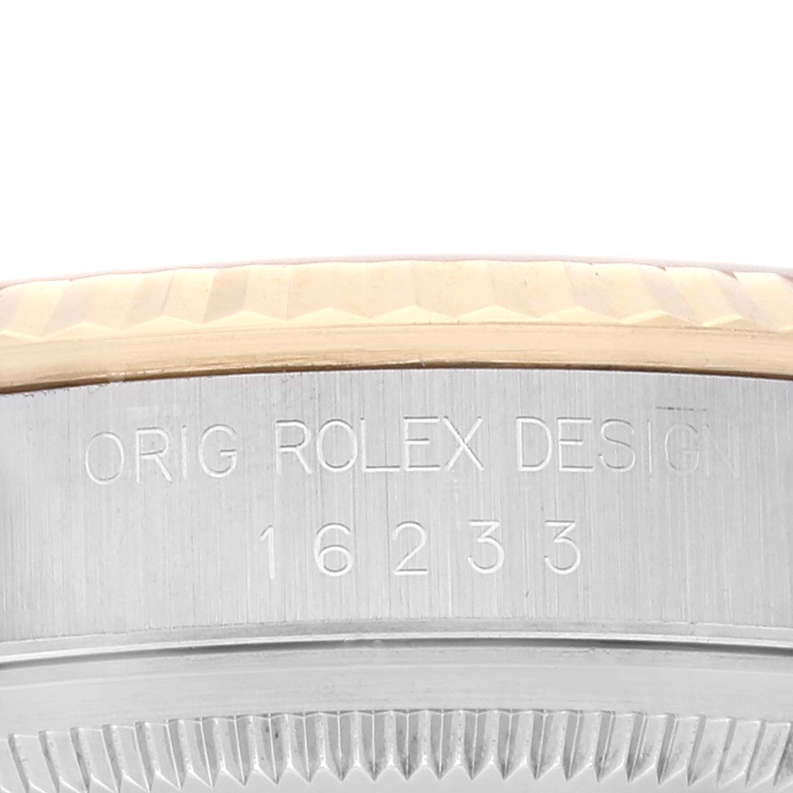 The image shows an angled close-up of the Rolex Datejust 16233 Men's Steel and Gold (two tone) Champagne Dial 16233 Men's Steel and Gold (two tone) Champagne Dial's case side with engraving and part of the bezel.
