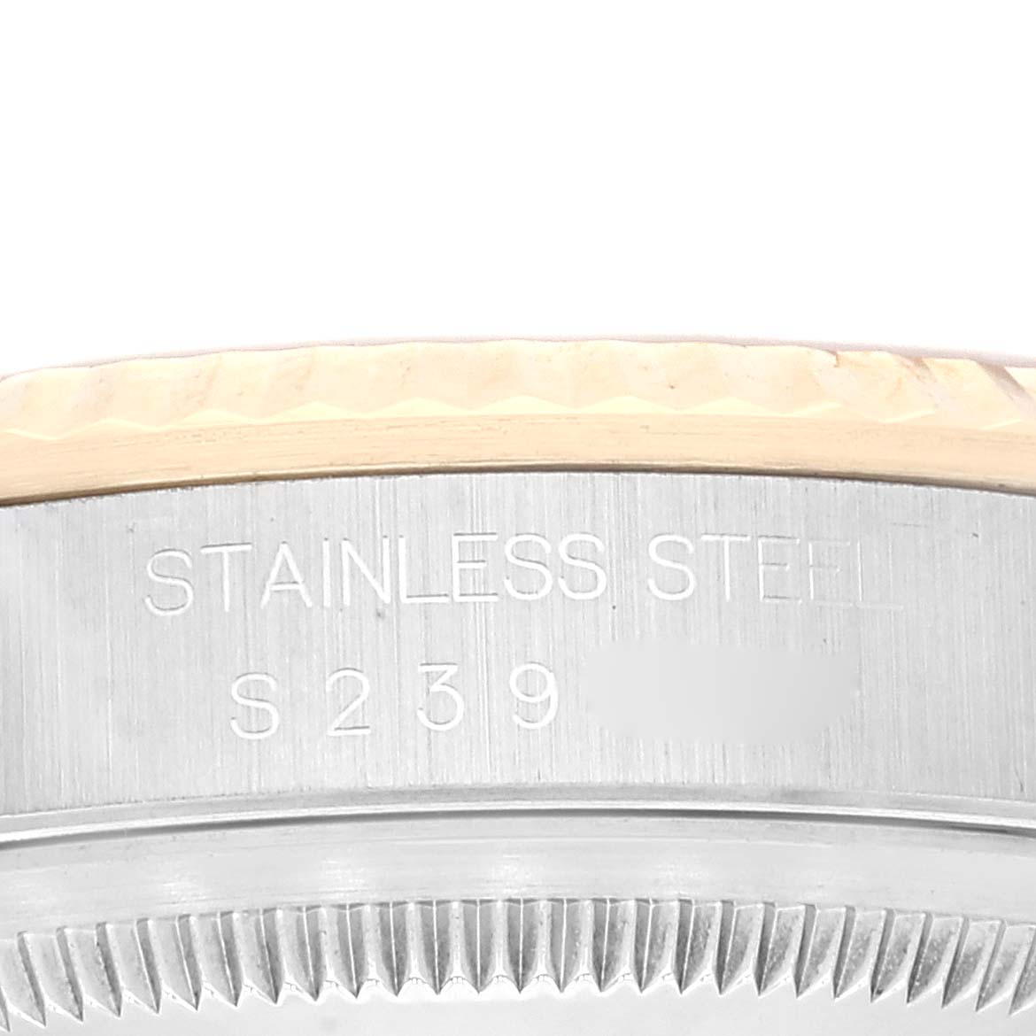 This close-up image shows the case side and part of the bezel with engravings on a Rolex Datejust 16233 Men's Steel and Gold (two tone) Champagne Dial 16233 Men's Steel and Gold (two tone) Champagne Dial watch.