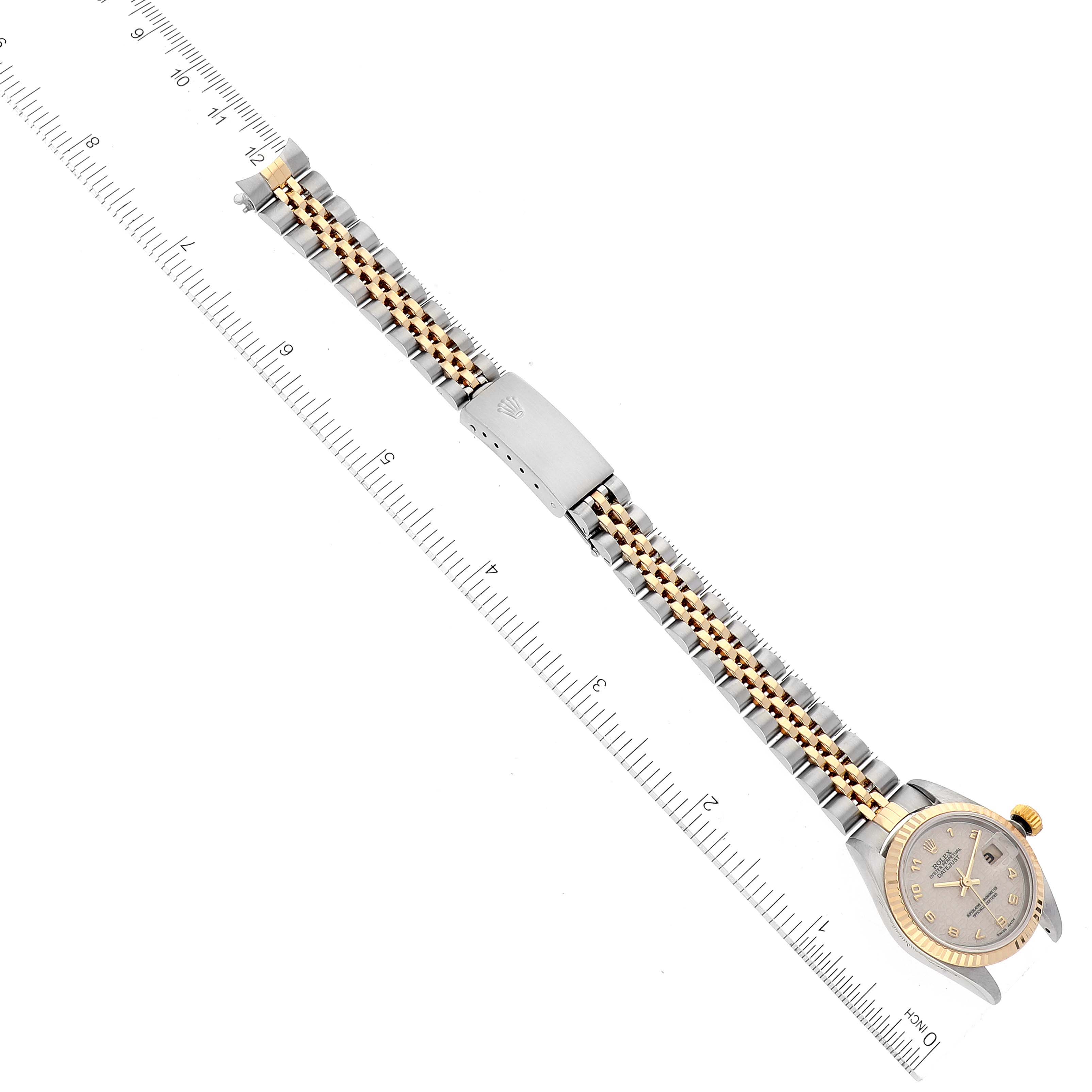 The image shows a Rolex Datejust 79173 Women's Steel and Gold (two tone) Beige Dial 79173 Women's Steel and Gold (two tone) Beige Dial watch laid flat with a ruler, displaying its face, bracelet, and clasp.