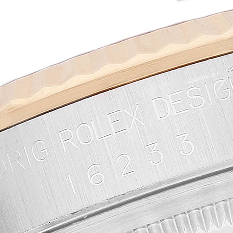 This image shows a close-up of the side engraving on the case and bezel of a Rolex Datejust 16233 Men's Steel and Gold (two tone) Grey Dial 16233 Men's Steel and Gold (two tone) Grey Dial watch.