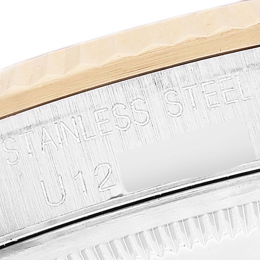 This is a close-up of the edge and bezel of a Rolex Datejust 16233 Men's Steel and Gold (two tone) Grey Dial 16233 Men's Steel and Gold (two tone) Grey Dial watch, showing "STAINLESS STEEL" engravings.