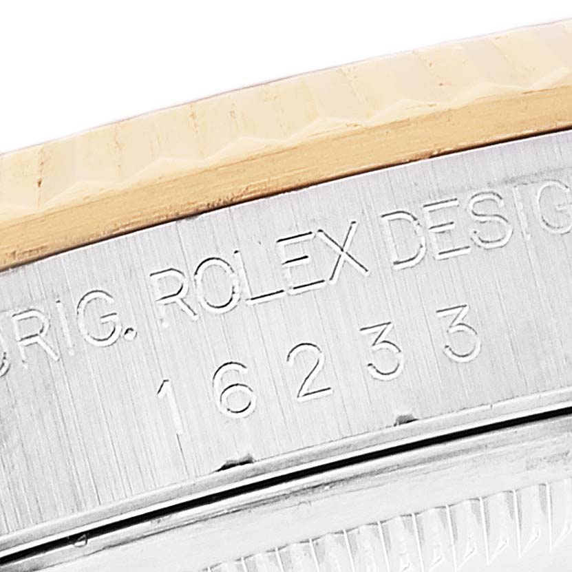 This close-up image displays the engraved model and serial number on the side of a Rolex Datejust 16233 Men's Steel and Gold (two tone) Grey Dial 16233 Men's Steel and Gold (two tone) Grey Dial watch case.