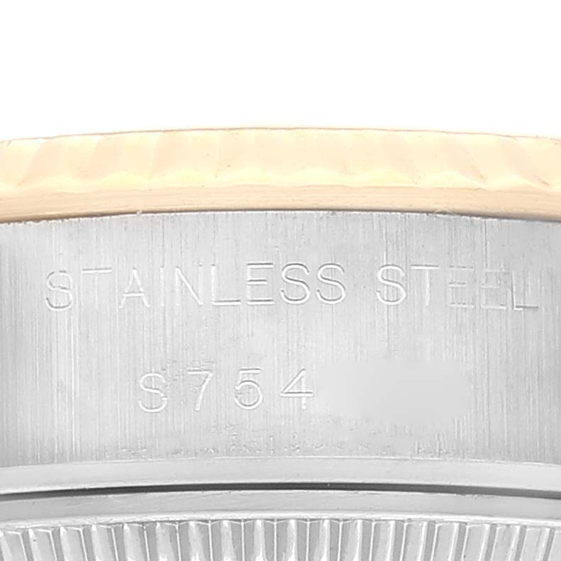 This image shows a close-up of the stainless steel back casing of a Rolex Datejust 69173 Women's Steel and Gold (two tone) Grey Dial 69173 Women's Steel and Gold (two tone) Grey Dial watch, featuring engraved text.