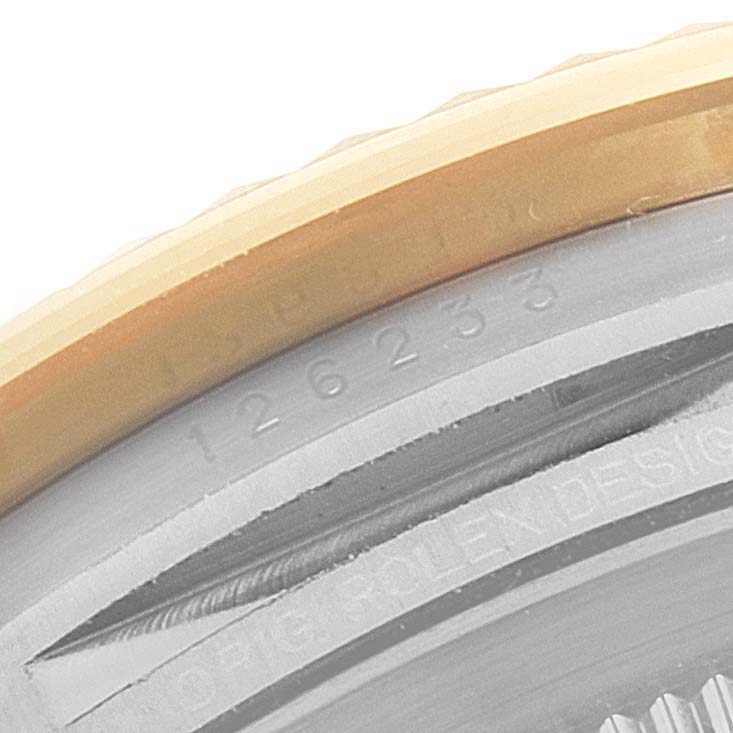 The image shows a close-up of the serial number and part of the bezel of a Rolex Datejust 126233 Men's Steel and Gold (two tone) White Dial 126233 Men's Steel and Gold (two tone) White Dial watch.