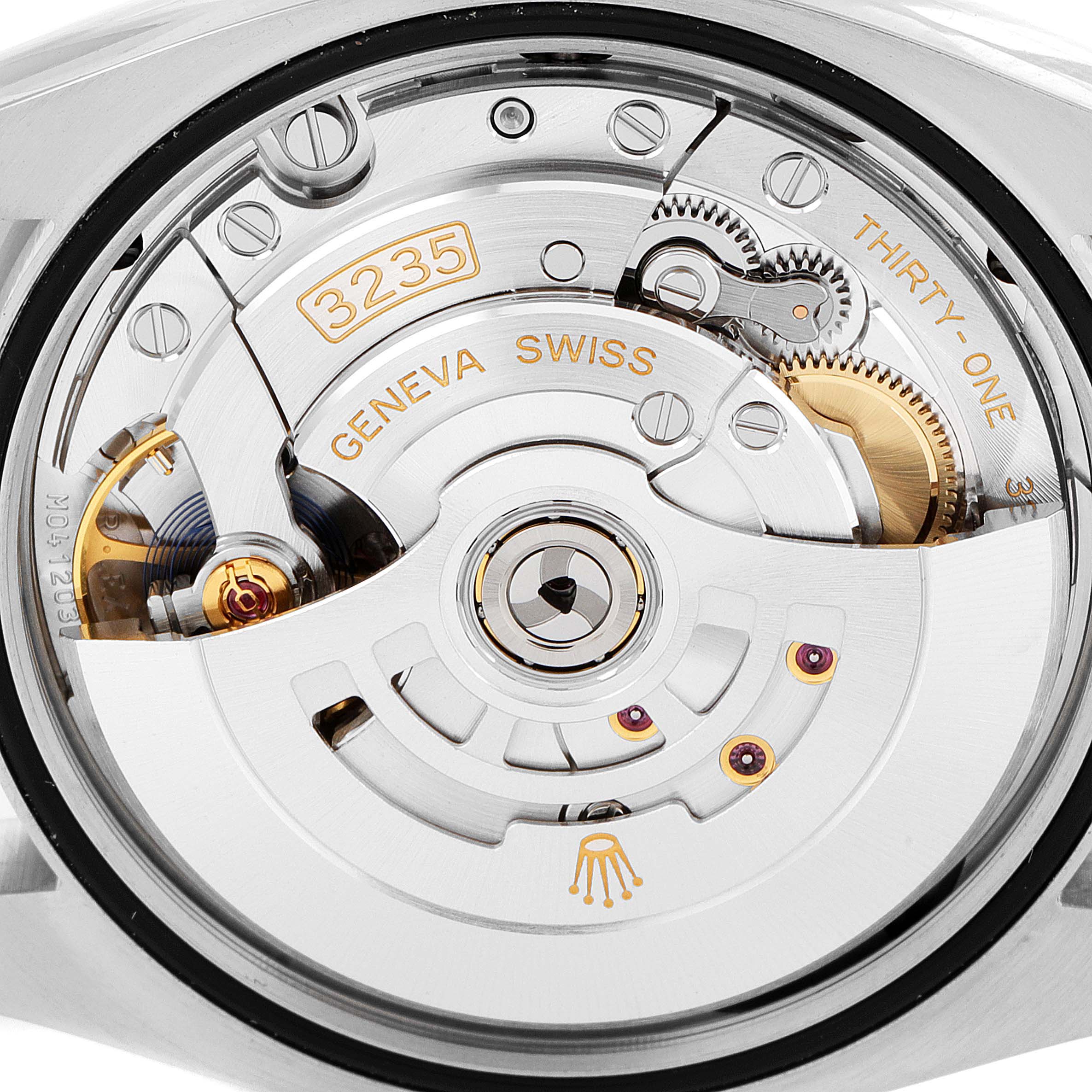 This image shows a close-up of the movement's rotor and gears of a Rolex Datejust 126233 Men's Steel and Gold (two tone) White Dial 126233 Men's Steel and Gold (two tone) White Dial watch.