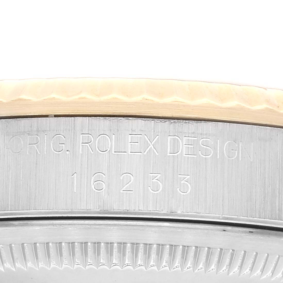 This close-up image shows the engraved model number and part of the bezel for a Rolex Datejust 16233 Men's Steel and Gold (two tone) White Dial 16233 Men's Steel and Gold (two tone) White Dial watch.