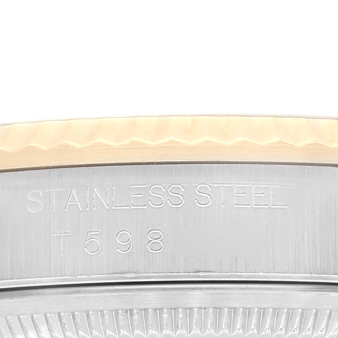 This image shows a close-up of the side of a Rolex Datejust 16233 Men's Steel and Gold (two tone) White Dial 16233 Men's Steel and Gold (two tone) White Dial watch, highlighting its stainless steel case and engraved model number.