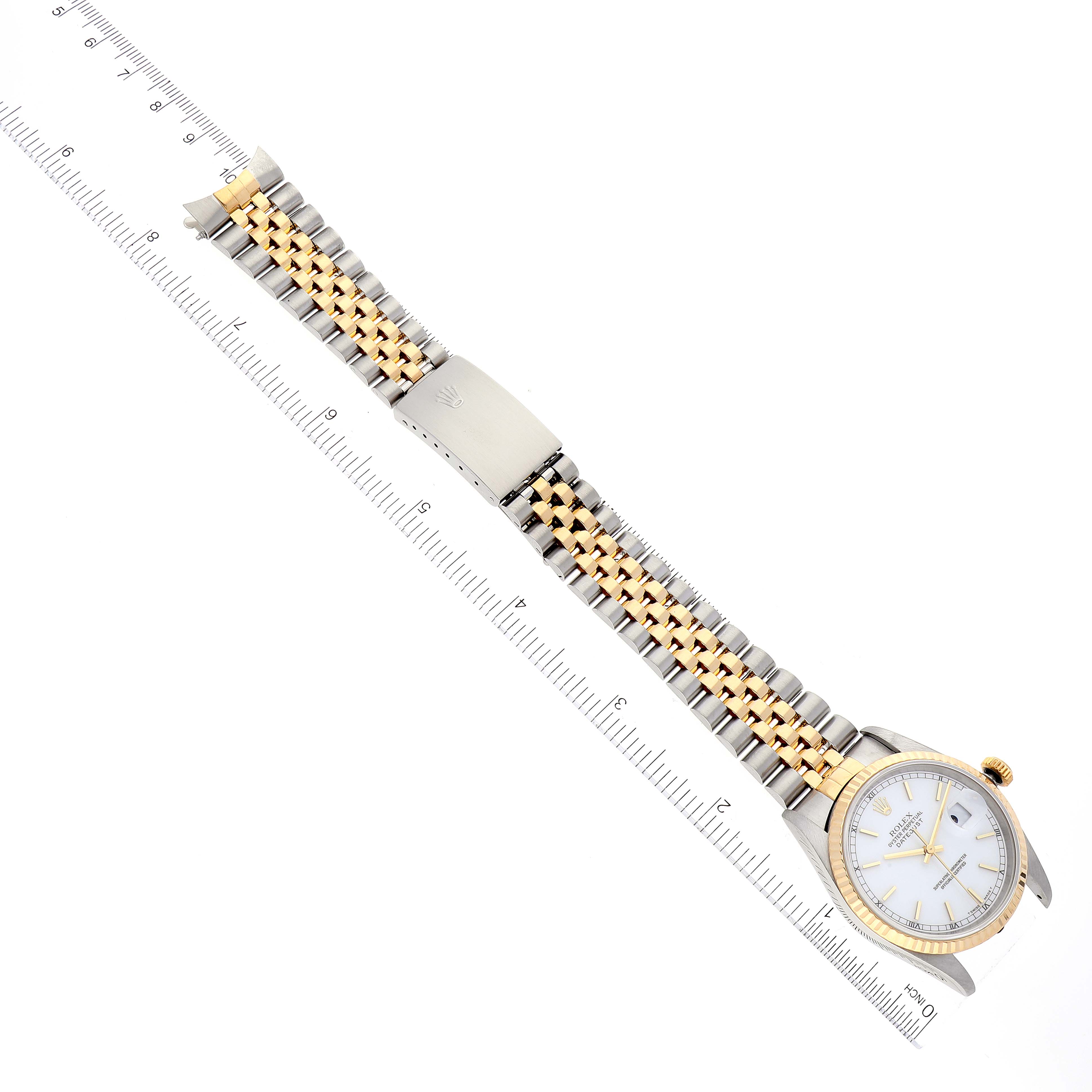 This image shows a Rolex Datejust 16233 Men's Steel and Gold (two tone) White Dial 16233 Men's Steel and Gold (two tone) White Dial watch laid flat, displaying its white dial, gold bezel, and two-tone bracelet with a deployed clasp.