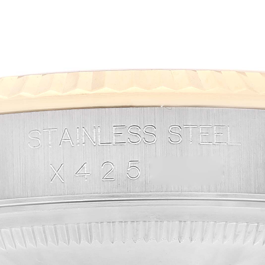 This close-up image shows the side of a Rolex Datejust 16233 Men's Steel and Gold (two tone) White Dial 16233 Men's Steel and Gold (two tone) White Dial watch, highlighting its stainless steel case with engraved text.