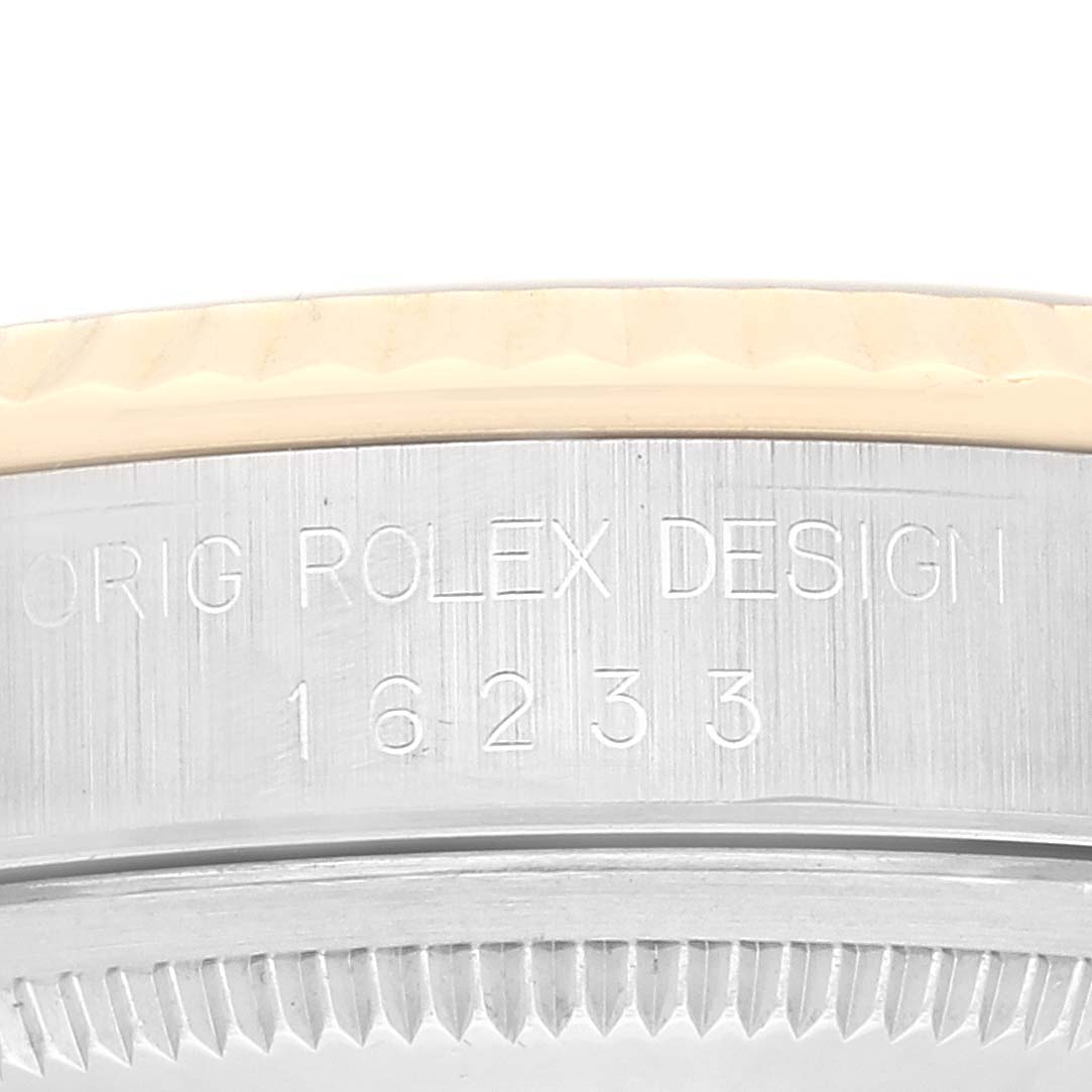The image shows a close-up of the case side of a Rolex Datejust 16233 Men's Steel and Gold (two tone) White Dial 16233 Men's Steel and Gold (two tone) White Dial, with the engraving "ORIG ROLEX DESIGN 16233".