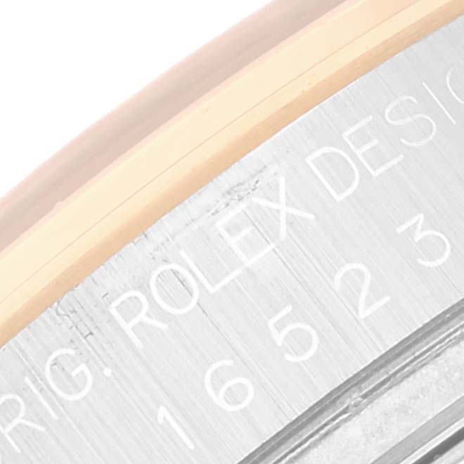 A close-up view of the etched inscription on the case side of a Daytona model Rolex watch.