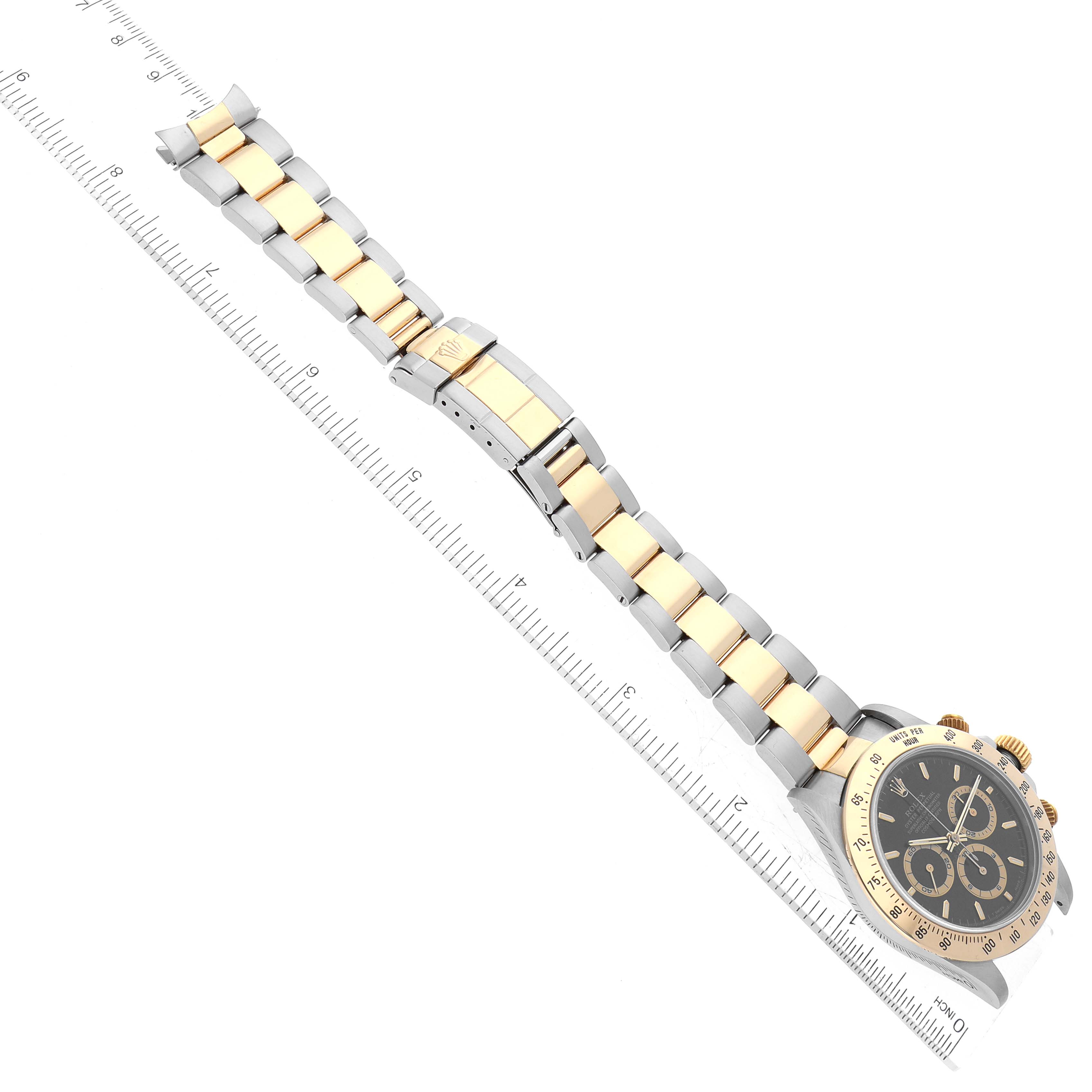 This image shows a Rolex Daytona 16523 Men's Steel and Gold (two tone) Black Dial 16523 Men's Steel and Gold (two tone) Black Dial watch laid flat, highlighting its bracelet, clasp, and face from a top-down angle.