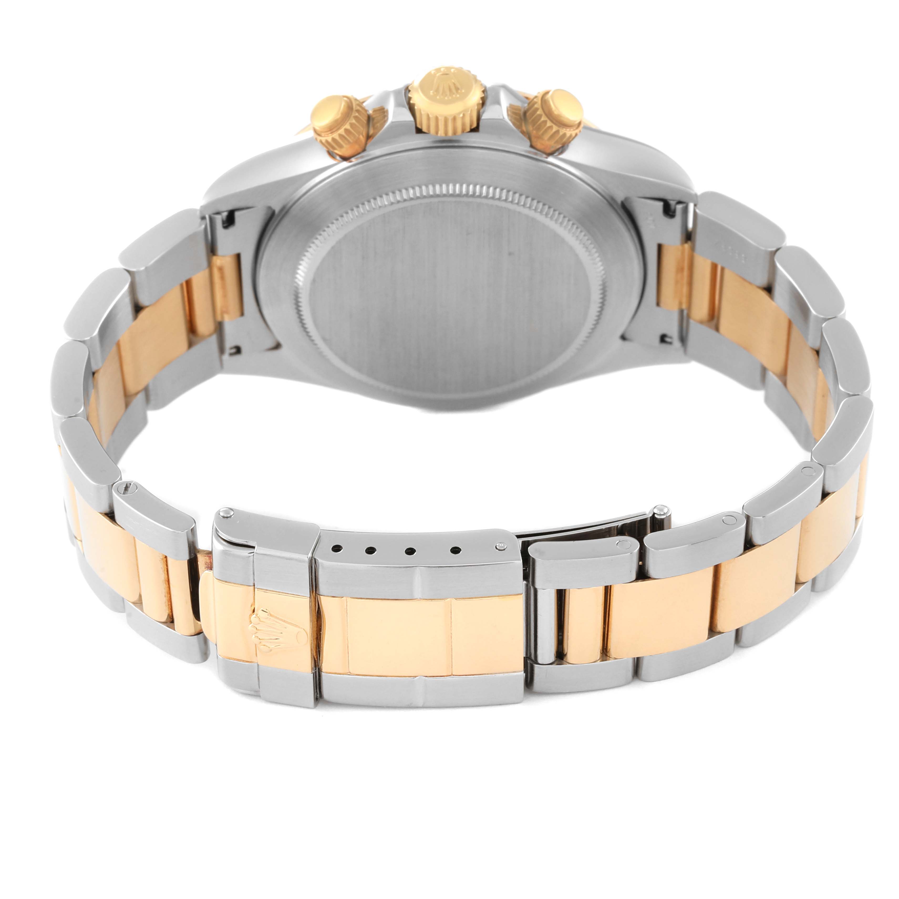 The image shows the backside and the bracelet clasp of a Rolex Daytona 16523 Men's Steel and Gold (two tone) Black Dial 16523 Men's Steel and Gold (two tone) Black Dial watch with a two-tone metal finish.