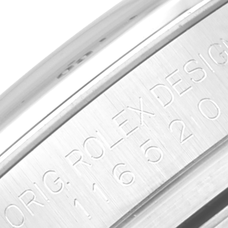 The image shows a close-up of the model number "116520" and "Orig Rolex Design" engraving on the Daytona model by Rolex.