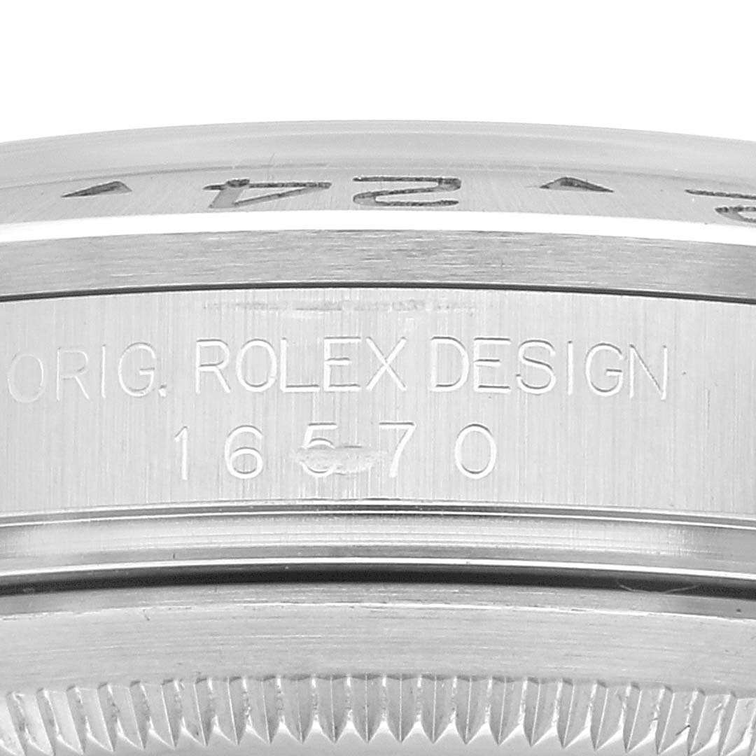 The image shows a close-up view of the case side and bezel of a Rolex Explorer 16570 Men
s Stainless Steel White Dial 16570 Men
s Stainless Steel White Dial watch, featuring the model number "16570" and "ORIG. ROLEX DESIGN" engraving.