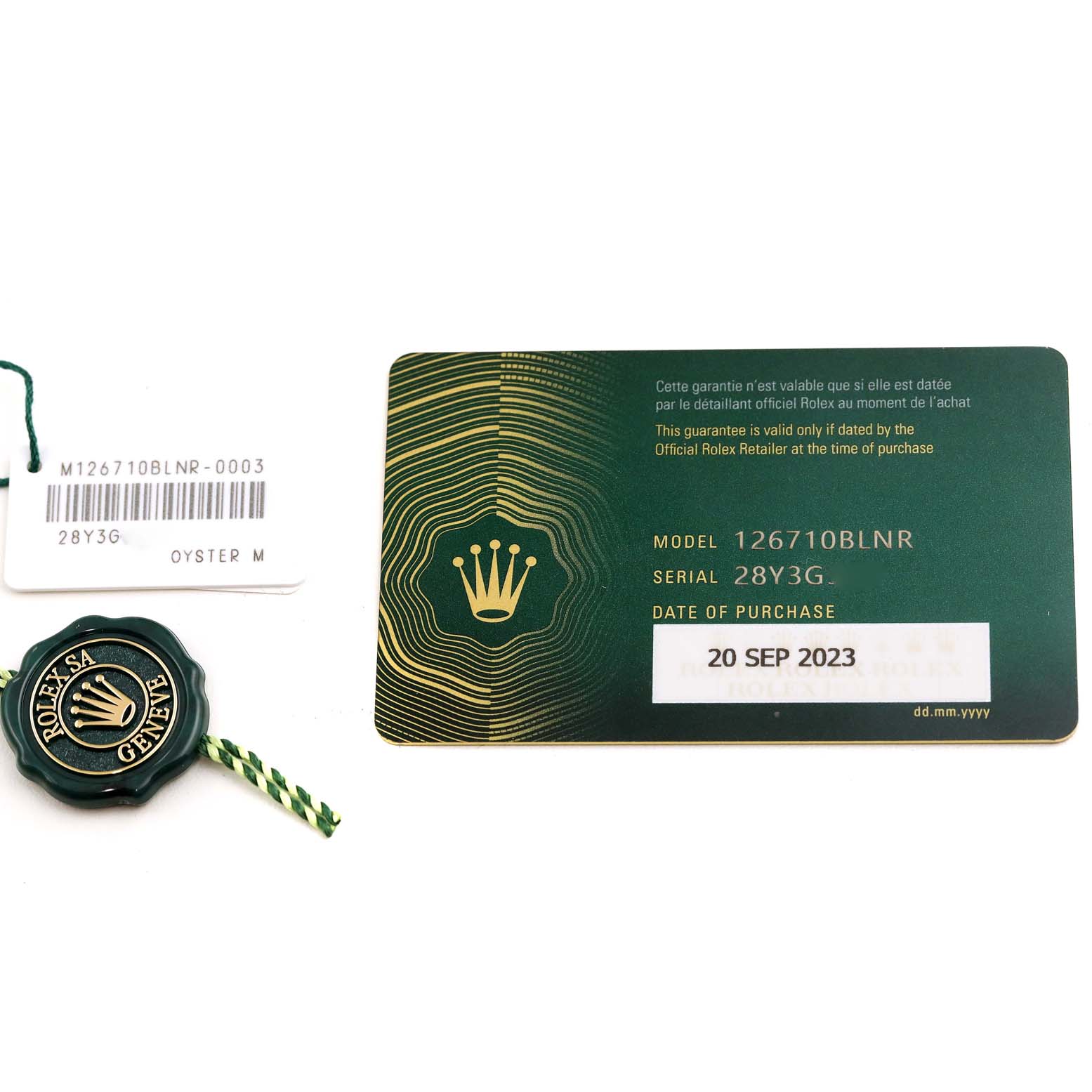The image shows a warranty card, tag, and seal for a Rolex GMT-Master 126710 Men's Stainless Steel Black Dial 126710 Men's Stainless Steel Black Dial model 126710BLNR.